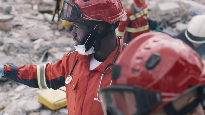 An aid worker surveys earthquake damage