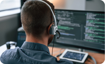 Man working on computer with headphones